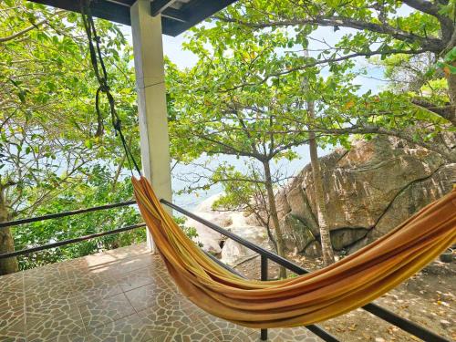 a hammock on a porch with a view of the ocean at Tao Thong Villa 2 in Ko Tao