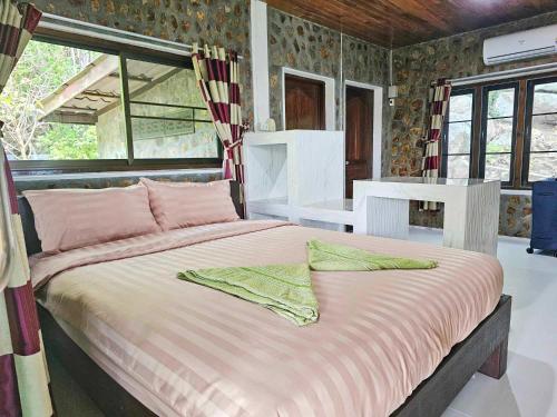 a bedroom with a large bed in a room at Tao Thong Villa 2 in Ko Tao