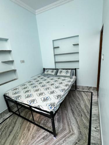 a small bedroom with a bed in a room at Rose Merry Guesthouse in Bikaner