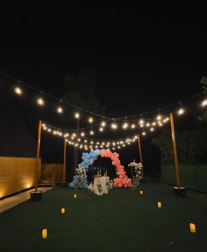 a stage with a bunch of lights and flowers at UpTown Batumi in Batumi