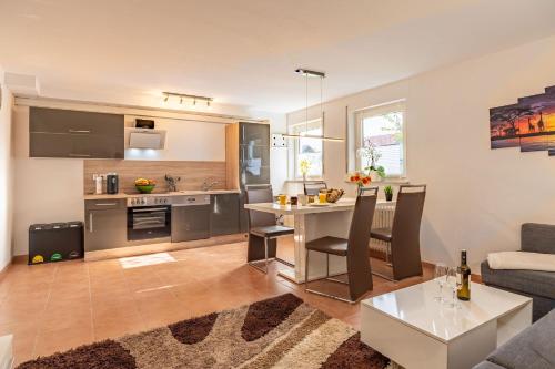 a kitchen and living room with a couch and a table at Bitzer Blick in Bitz