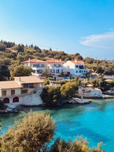 a group of houses next to a river at Paradise House apart3, 5min walking distance to Fiskardo center in Fiskardo