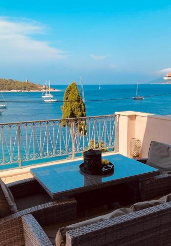 a balcony with a table and a view of the ocean at Paradise House apart3, 5min walking distance to Fiskardo center in Fiskardo