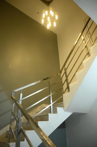 a staircase in a house with a chandelier at shangrila stay in Bodh Gaya
