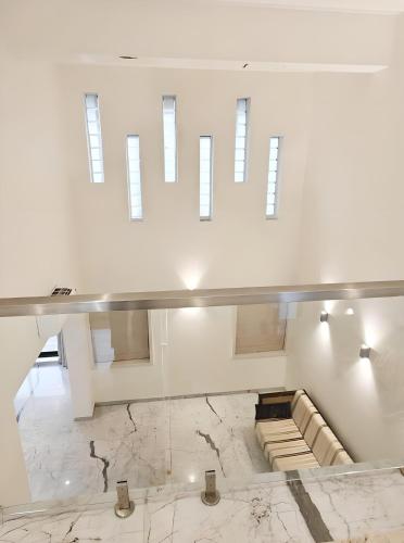 a large white room with a marble floor at Mizzle Exotica Lonavala in Lonavala