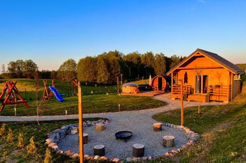 a playground with a small house at Dębowy Domek Mazury in Szczybały Giżyckie