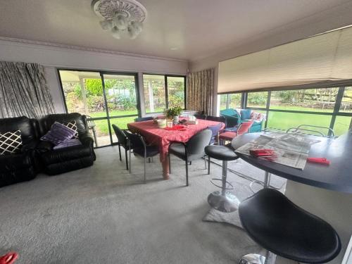 a living room with a table and chairs at RUs Terraces in Kauri