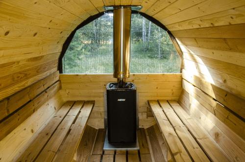 an inside view of a wooden cabin with a window at Dom na krańcu lasu in Ostrowy