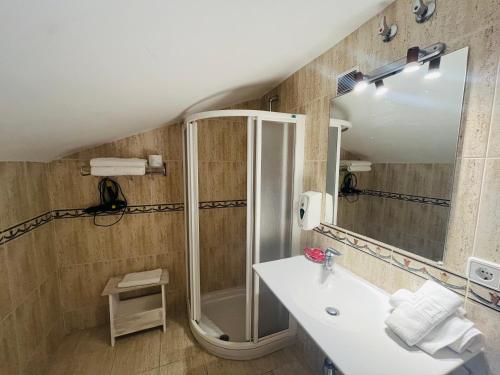 a bathroom with a shower and a sink and a mirror at HOTEL MUSEO Lucainena in Lucainena de las Torres