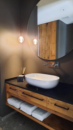 a bathroom with a large sink and a mirror at Il giardino di Anna - Appartamento 2 in Fai della Paganella