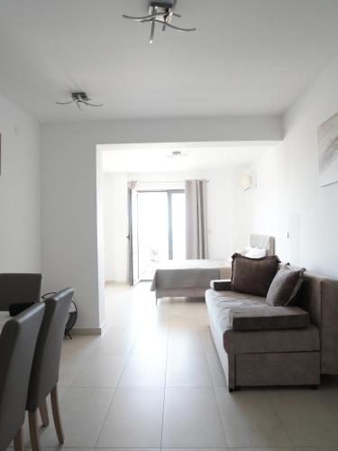 a living room with a couch and a bed at Apartman Bonaca in Pržno