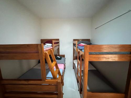 a small room with three bunk beds in it at Sariaya Quezon Transient in Sariaya