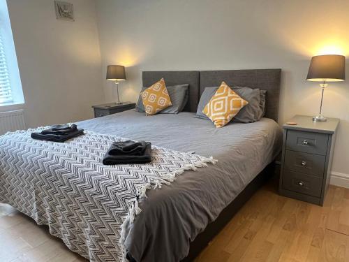 a bedroom with a bed with pillows and two lamps at Spacious ground floor suite comfortably sleeps up to eight in Halifax