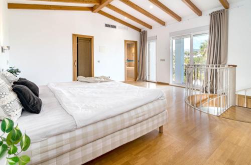 a white bedroom with a large bed in a room at GRR - Elegant Villa with Exclusive Private Pool in Marbella