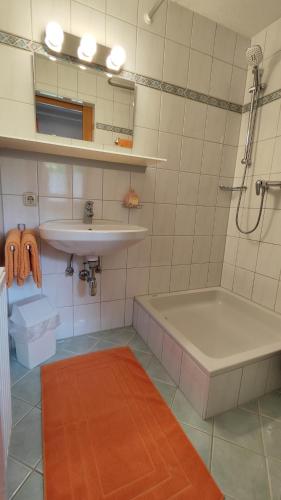 a bathroom with a sink and a tub and a sink at Haus Lädeler in Schruns