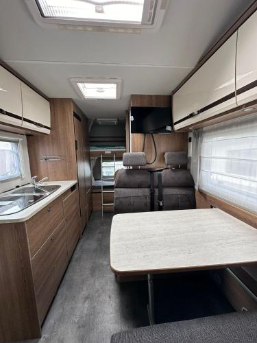 an rv kitchen with a table and a sink at Hotel na kolech in Kladno