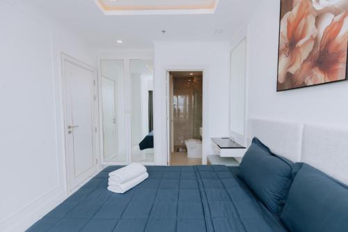 a living room with a blue couch and a painting at The Empire Tower k in Jomtien Beach