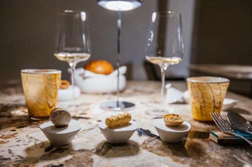 a table topped with plates of food and wine glasses at Villa Fiorella Art Hotel in Massa Lubrense
