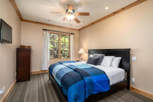 a bedroom with a bed and a ceiling fan at Luxurious Modern Condo! - SM #207 in Bear Valley