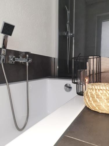 a bathroom with a shower and a bath tub at Ferienwohnung am Halfterweg in Hirschberg