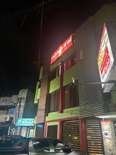 a building with a car parked in front of it at Ladybugs Hotel Nazareth in Cagayan de Oro