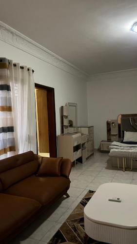 a living room with a couch and a table at Villa oiseaux in Dakar