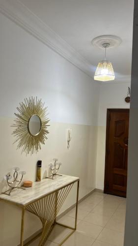 a room with a table and a mirror on the wall at Villa oiseaux in Dakar