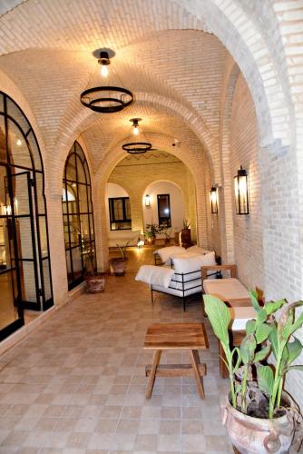 a large room with two beds and a couch at Dar Fatima in Tozeur