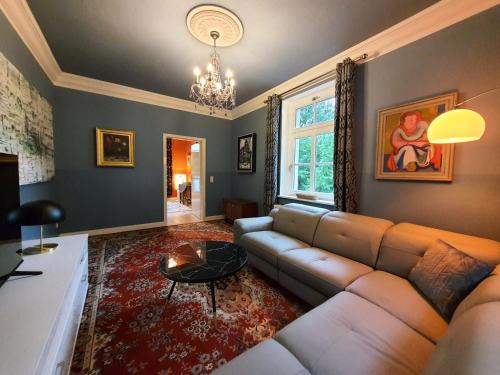 a living room with a couch and a table at ArtHouse Am Kurpark Bad Schandau in Bad Schandau