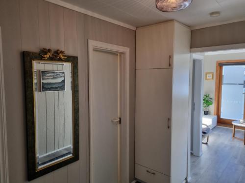 a mirror on the wall of a room at The Painter's house with view and balcony in Siglufjörður