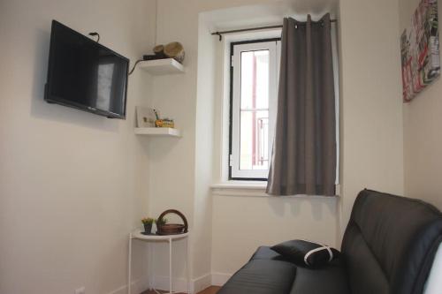 a living room with a couch and a window at Sweet Alfama, Apartment 1 in Lisbon