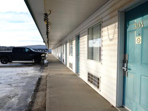 a hallway of a building with a truck parked next to it at The Ritz Cafe and Motor Inn in Whitecourt