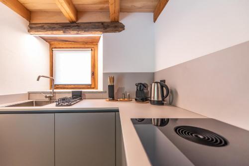 a kitchen with a sink and a counter top at Chalet 181 - Aosta Valley Mountain Stay in Arvier