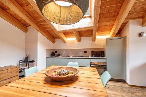 a kitchen with a wooden table with a bowl of fruit on it at Chalet 181 - Aosta Valley Mountain Stay in Arvier