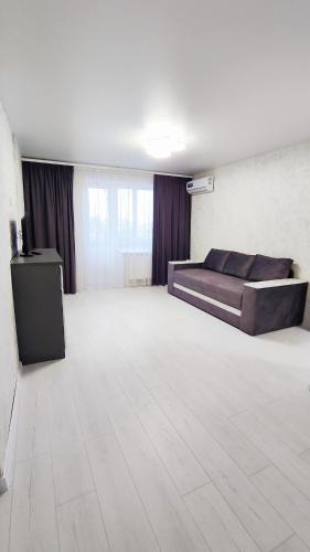 a large room with a bed and a white floor at Партизанська 23 CityRooms in Bila Tserkva