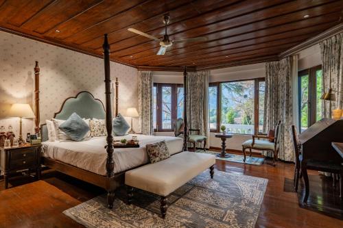 a master bedroom with a bed and a piano at Brij Anayra Dharamshala - A Himalayan Luxury Retreat in Dharamshala