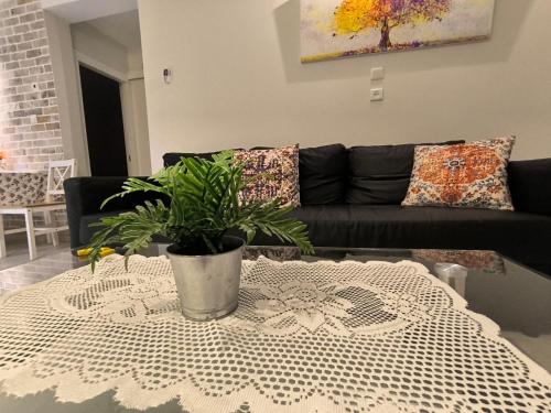 a living room with a black couch and a table at The-Home-Away-From-Home in Eilat