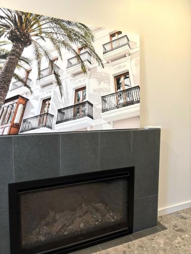 a fireplace in front of a building with a palm tree at Versatile summer beach house or cosy winter retreat! in Mandurah