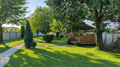 a gazebo in the middle of a yard at Green Land Club in Novi Banovci