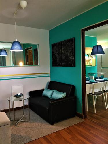 a living room with a black couch and a table at White Turquoise -2 Bedrooms Apartment- in Bangkok