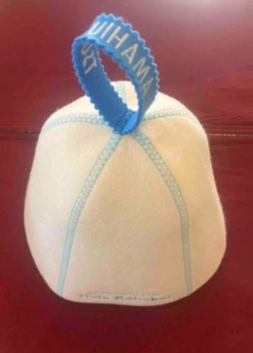 a baseball hat with a blue ribbon on it at Oceanfront Villa Hale Kahakai プライベートサウナ in Kōembō