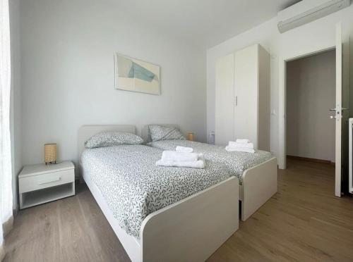 a bedroom with a bed in a white room at Alma House in Finale Ligure