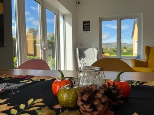 a table with pumpkins and a glass jar on a table at Mon Petit Cottage - B&B and Guest House in Bunclody in Bunclody