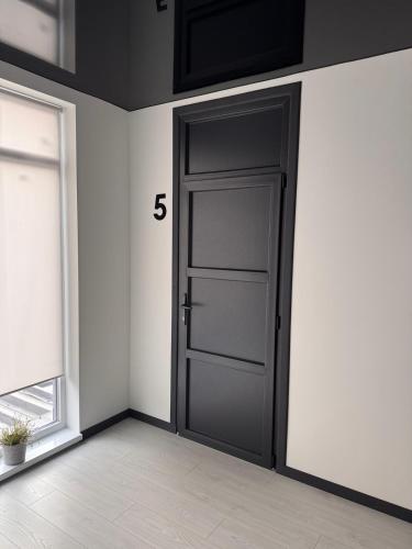 an empty room with a door with the number at Готель WeLKoMe in Krivorovnya