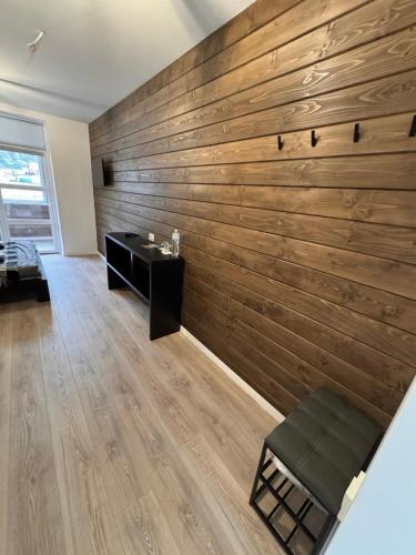 a living room with a large wooden wall at Готель WeLKoMe in Krivorovnya