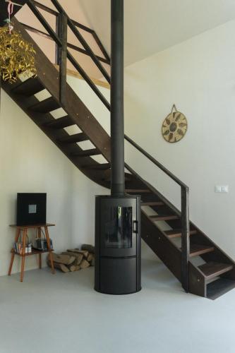 a fireplace in a living room next to a staircase at Preria Odargowo in Odargowo