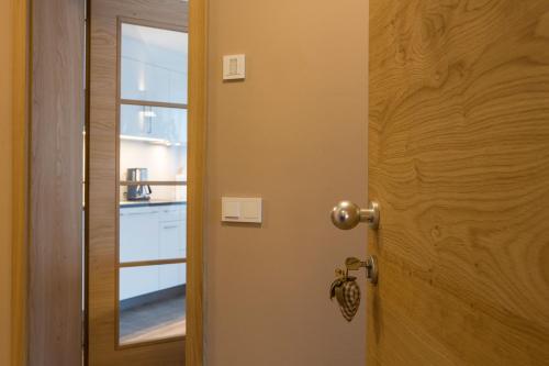a door with a mirror next to a kitchen at Chalet S Apartments in Campo Tures