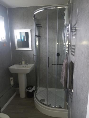 a bathroom with a shower and a sink at Meadow Crest in Great Yarmouth