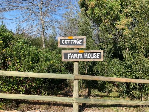 a sign that says coffee farmhouse and a farm house at Trinity Farm Ocean view Cottage in Plettenberg Bay