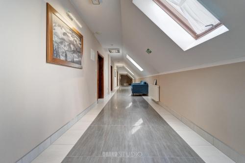 a long hallway with a skylight in a building at Pensjonat EDEN Maniowy in Maniowy